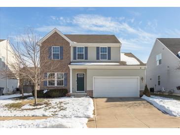 Two-story brick and beige house with a green door and attached garage at 15256 Harmon Pl, Noblesville, IN 46060