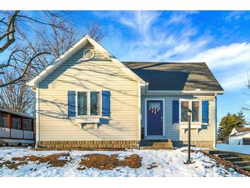 Charming one-story home with blue shutters and snowy front yard at 207 E Ohio St, Fortville, IN 46040