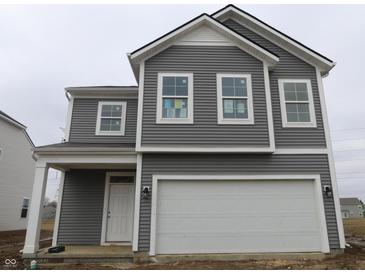 A two-story home with gray siding and a white garage door, showing the front exterior at 5144 Rolling Meadow Blvd, Indianapolis, IN 46237