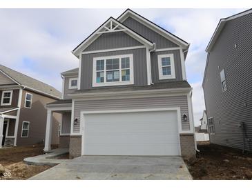 Two-story house with gray siding, white garage door, and a brick walkway at 5147 Rolling Meadow Blvd, Indianapolis, IN 46237