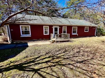 Charming one-story home with red siding, white trim, and a cozy front porch at 8660 S Peoga Rd, Trafalgar, IN 46181