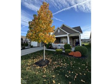 Attractive ranch home with autumn landscaping and pumpkins at 8737 Twain Ln, Indianapolis, IN 46239