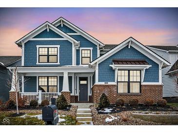 Two-story home with blue siding, brick accents, and a welcoming front porch at 1574 Mairn Ave, Carmel, IN 46032