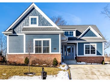 Charming blue two-story home with brick foundation, manicured lawn, and a welcoming front entrance at 20188 Hampton Park Dr, Westfield, IN 46074