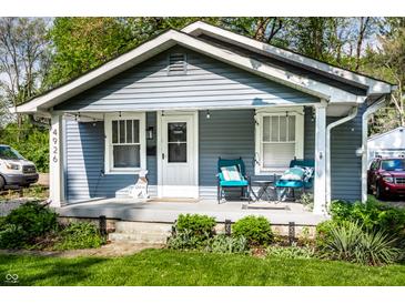 Charming bungalow-style home with inviting porch and manicured front yard at 4926 Crittenden Ave, Indianapolis, IN 46205