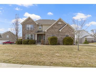 Charming brick home with mature landscaping and a welcoming front entrance at 11383 Sea Side Ct, Fishers, IN 46040