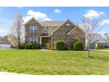 Charming two-story brick home with lush green lawn and blossoming trees, offering curb appeal at 11383 Sea Side Ct, Fishers, IN 46040