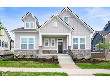 Two-story craftsman home with stone accents and a welcoming front porch at 20035 Meadow Neck Rd, Westfield, IN 46074