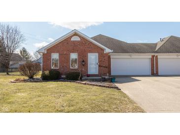 Charming red brick townhome features a well-manicured lawn and an attached one-car garage at 306 Vinewood N Dr, Brownsburg, IN 46112