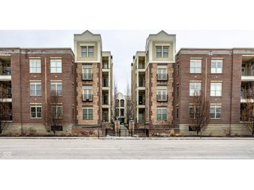 Brick building with multiple units and gated entrance at 450 E Ohio St # 106, Indianapolis, IN 46204