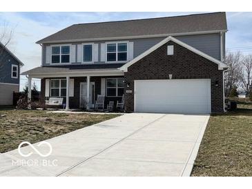 Charming two-story home with a brick-accented garage and inviting front porch with swing at 6250 Bales Dr, Plainfield, IN 46168
