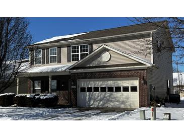 Two-story house with brick and siding exterior, attached garage, and snow-covered landscaping at 10652 Brighton Knoll N Pkwy, Noblesville, IN 46060