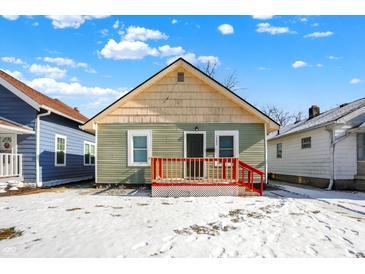 Green house with red deck and snowy front yard at 1503 N Grant Ave, Indianapolis, IN 46201