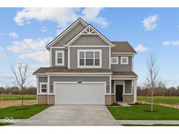 Charming two-story home with gray siding, white trim, two-car garage, and landscaped yard at 2310 Marjorie Way, Shelbyville, IN 46176