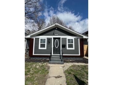 Charming single-story home with gray siding, a front yard, and a well-manicured lawn at 2320 Spann Ave, Indianapolis, IN 46203