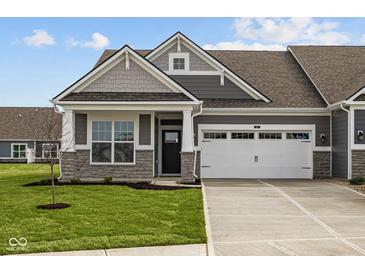 Charming home featuring a two-car garage, stone accents, and well-manicured lawn at 3617 Wrangler Dr, Bargersville, IN 46106