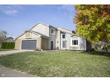 Two-story house with a two-car garage and landscaped yard at 7904 Madden Dr, Fishers, IN 46038