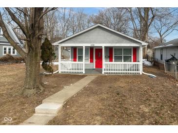 Gray house with red door and porch, steps leading to the entrance at 1130 W 33Rd St, Indianapolis, IN 46208