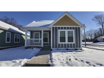 Charming craftsman style home with gray siding and a snowy front yard at 1401 N Pershing Ave, Indianapolis, IN 46222