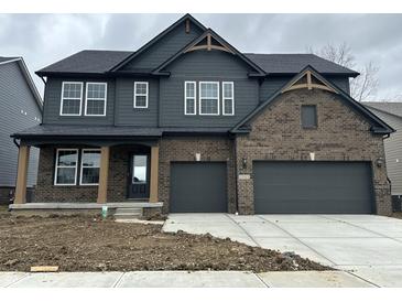Charming two-story home features brick and gray wood, two-car garage, and stylish architectural details at 19983 Boulder Brook Ln, Westfield, IN 46074
