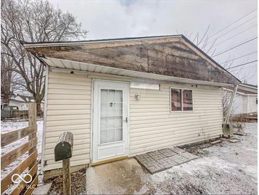 Small ranch home with damaged roofline and mailbox at 216 W 27Th St, Anderson, IN 46016