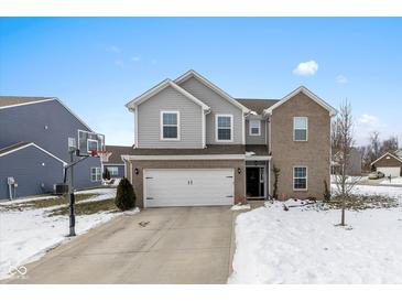 Two-story brick home with attached garage and basketball hoop at 4046 Stubbington Ln, Indianapolis, IN 46239