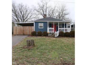 Charming blue bungalow with white porch and red door at 50 N Edmondson Ave, Indianapolis, IN 46219