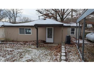 Tan house with snow covered yard and small covered porch at 3 Lake Hart, Mooresville, IN 46158