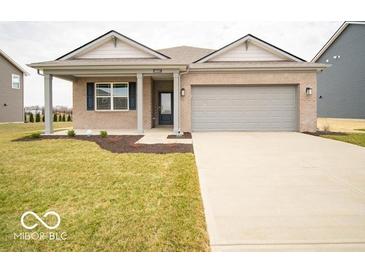 Charming single-story brick home with a covered porch and well-maintained front yard at 6047 Granby Dr, Whitestown, IN 46075