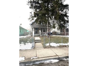 Charming two-story house with a front porch and fenced yard at 1348 N Lasalle St, Indianapolis, IN 46201