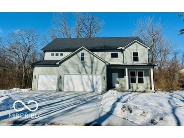 Two-story house with three-car garage and snowy front yard at 1644 Hunting Horn Cir, Indianapolis, IN 46260