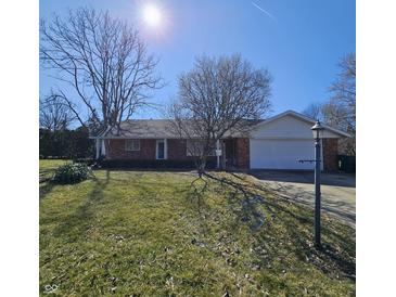 Charming brick home with a well-maintained lawn on a sunny day at 2509 W Euclid Ave, Muncie, IN 47304