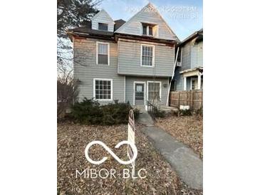 Charming two-story home with detailed framework, awaiting your personal touch to restore it to its former glory at 340 W 11Th St, Anderson, IN 46016
