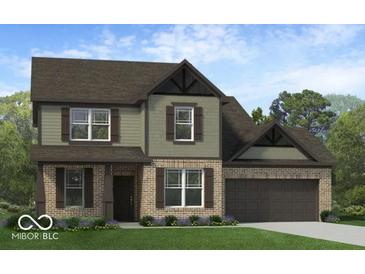 Two-story house with brick and siding, a large garage, and landscaping at 385 N Post Oak Dr, Mooresville, IN 46158