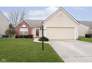Charming single-Gathering home featuring a well-manicured lawn, a two-car garage, and a welcoming front entrance at 12243 Carriage Stone Dr, Fishers, IN 46037
