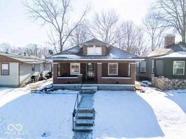 Brick home with front porch and steps, winter scene at 1307 W Congress Ave, Indianapolis, IN 46208