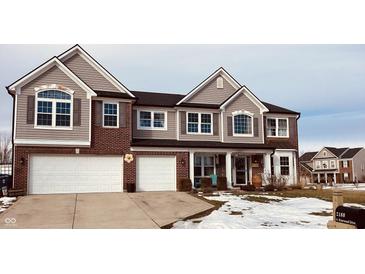 Two-story house with brick and siding, two-car garage, and snowy front yard at 2188 S Briarwood Dr, New Palestine, IN 46163