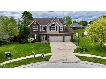 Charming exterior of a two-story home featuring a spacious driveway and well-manicured lawn at 861 Stardust Ct, Franklin, IN 46131