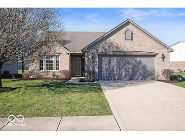 Brick ranch home with attached garage and landscaped lawn at 2322 Bainbridge Rd, Greenwood, IN 46143