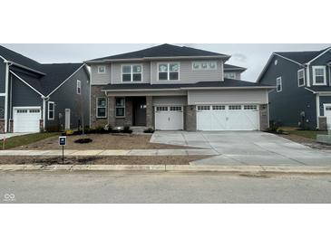 New construction two-story home with gray siding, brick accents, and a two-car garage at 5326 Noble Crossing W Pkwy, Noblesville, IN 46062