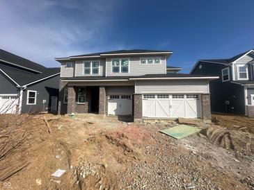 New two-story home featuring a brick facade and a two-car garage, set against a clear blue sky at 5326 Noble Crossing W Pkwy, Noblesville, IN 46062