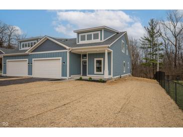 Craftsman style home with gray siding, white trim, and a two-car garage at 5943 Crooked Creek Dr, Indianapolis, IN 46228