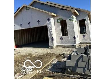 New construction home featuring an attached two-car garage and visible framing at 1089 Tomahawk Pl, Martinsville, IN 46151