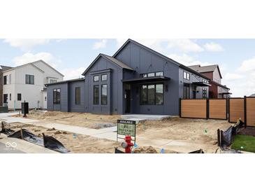 Modern two-story home featuring a stylish gray exterior, complemented by sleek black window frames and a minimalist landscape at 1674 Solebar Way, Westfield, IN 46074