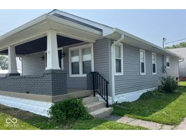 Charming single-story home with gray siding, covered porch, and well-maintained landscaping at 18 S Franklin St, Greenfield, IN 46140