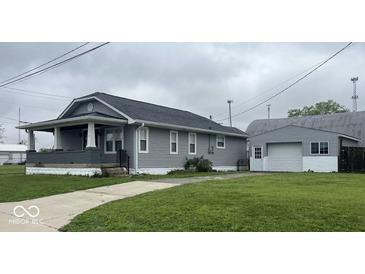 Charming single Gathering home with an inviting front porch and detached garage, perfect for storage and hobbies at 18 S Franklin St, Greenfield, IN 46140
