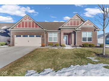 Brick ranch home with a two-car garage and landscaped lawn at 5246 Parkhurst Xing, McCordsville, IN 46055