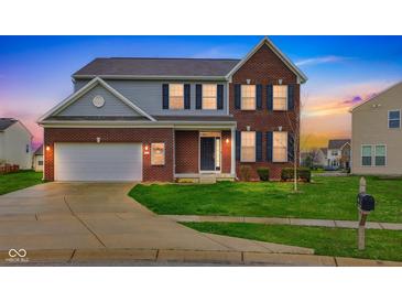 Inviting two-story brick home featuring a well-manicured lawn and attached two-car garage at 1284 Jesse Ct, Greenwood, IN 46143