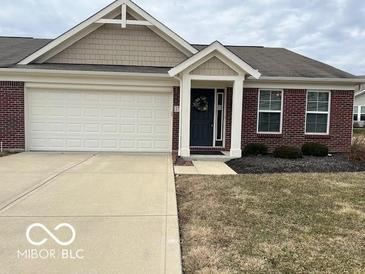 Charming single-story home featuring a brick facade, attached garage, and cozy front porch at 17238 Falkland Dr, Westfield, IN 46074