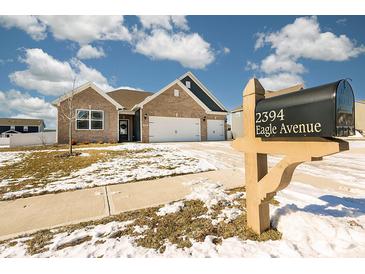 Brick house with a two-car garage and landscaping; mailbox at the end of the driveway at 2394 Eagle Ave, Plainfield, IN 46168